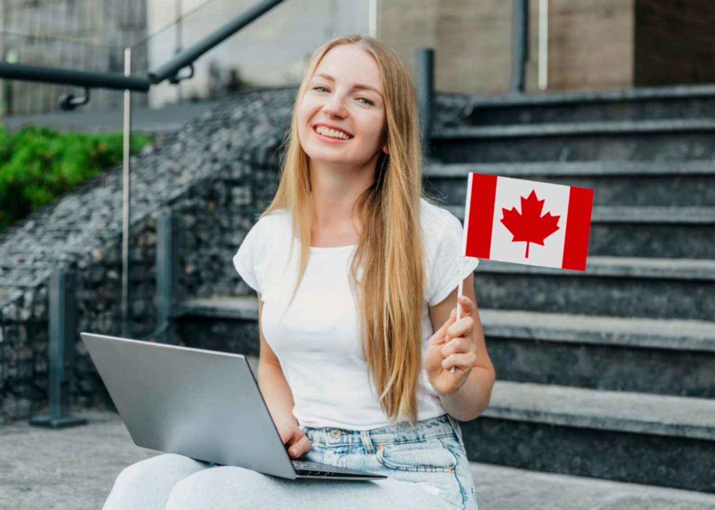 Girl waving Canadian flag after entering via temporary residency program
